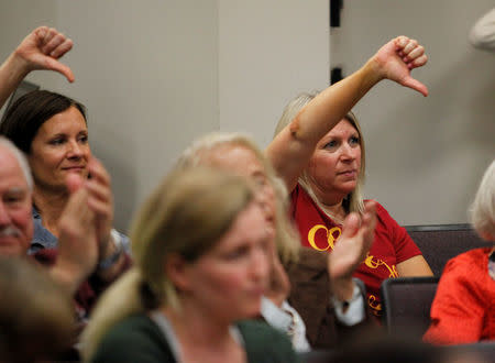 Two people gesture as U.S. Senator Tim Scott (R-SC) makes a point at a town hall meeting in North Charleston, South Carolina, U.S. February 25, 2017. REUTERS/Randall Hill