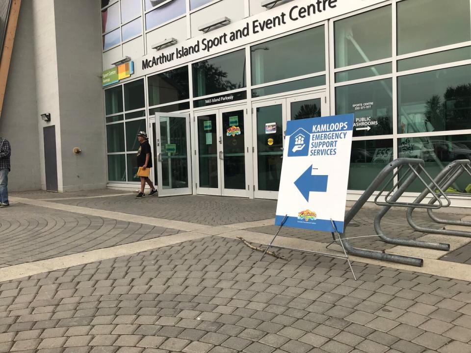 A man walks out of the McArthur Island Sport and Event Centre on Wednesday, Aug. 23, 2023, where he received information and support as a wildfire evacuee.