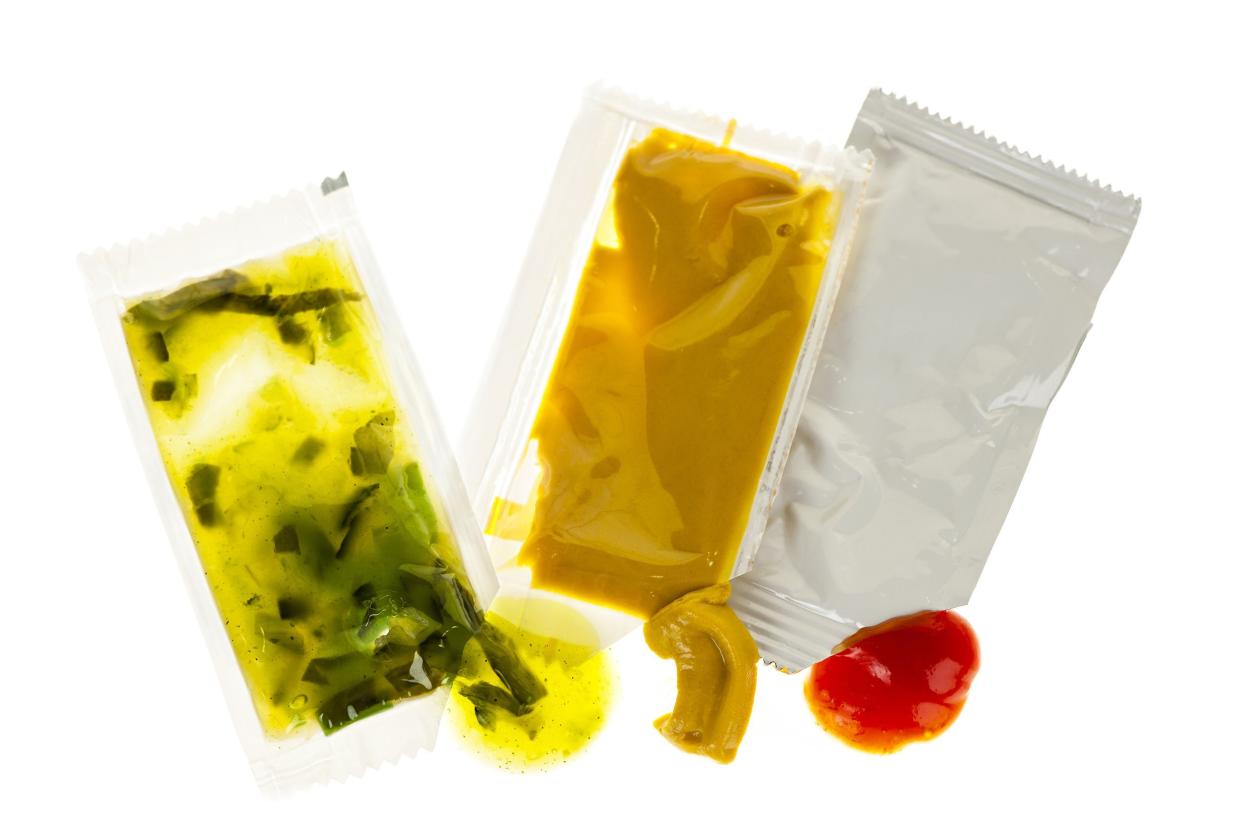 opened relish, mustard, and ketchup condiment packets