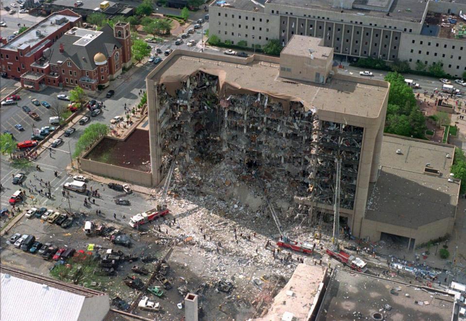 An aerial photo from 1995 shows a nine-story building missing a side and debris strewn below after a bombing in Oklahoma City