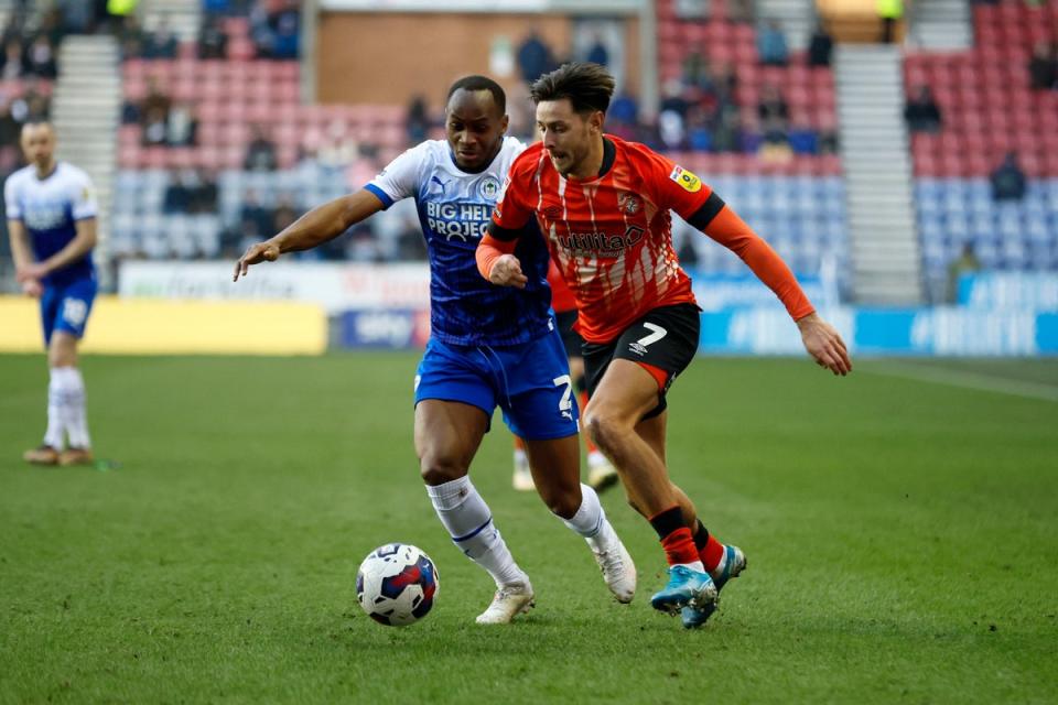 Luton Town’s Harry Cornick and Wigan Athletic’s Ryan Nyambe challenge for the ball (PA)