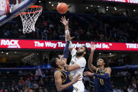 Wake Forest forward Efton Reid III, center, shoots between Notre Dame forwards Kebba Njie, left, and Carey Booth, right, during the first half of an NCAA college basketball game in the second round of the Atlantic Coast Conference tournament, Wednesday, March 13, 2024, in Washington. (AP Photo/Susan Walsh)