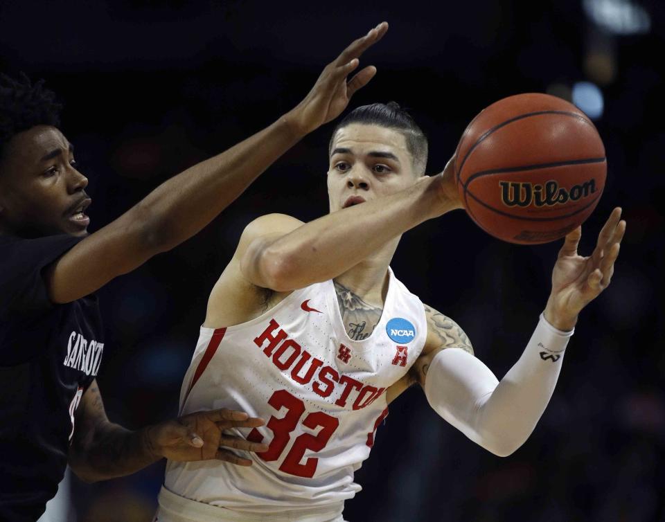 Houston guard Rob Gray, right, is pressured by San Diego State guard Jeremy Hemsley, left, during the first half of an NCAA men’s college basketball tournament first-round game Thursday, March 15, 2018, in Wichita, Kan. (AP Photo/Charlie Riedel)