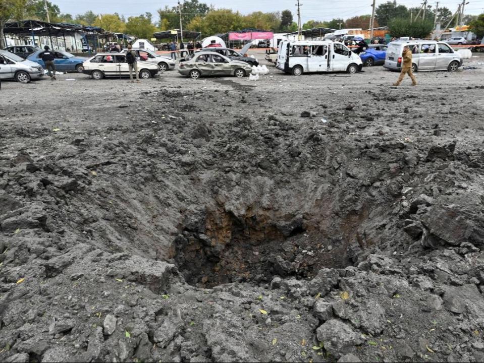 A crater was eft by a Russian missile strike that hit a convoy of civilian vehicles in Ukraine (REUTERS)