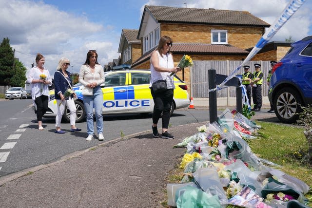 People leave flowers at Ashlyn Close, Bushey (Jonathan Brady/PA)