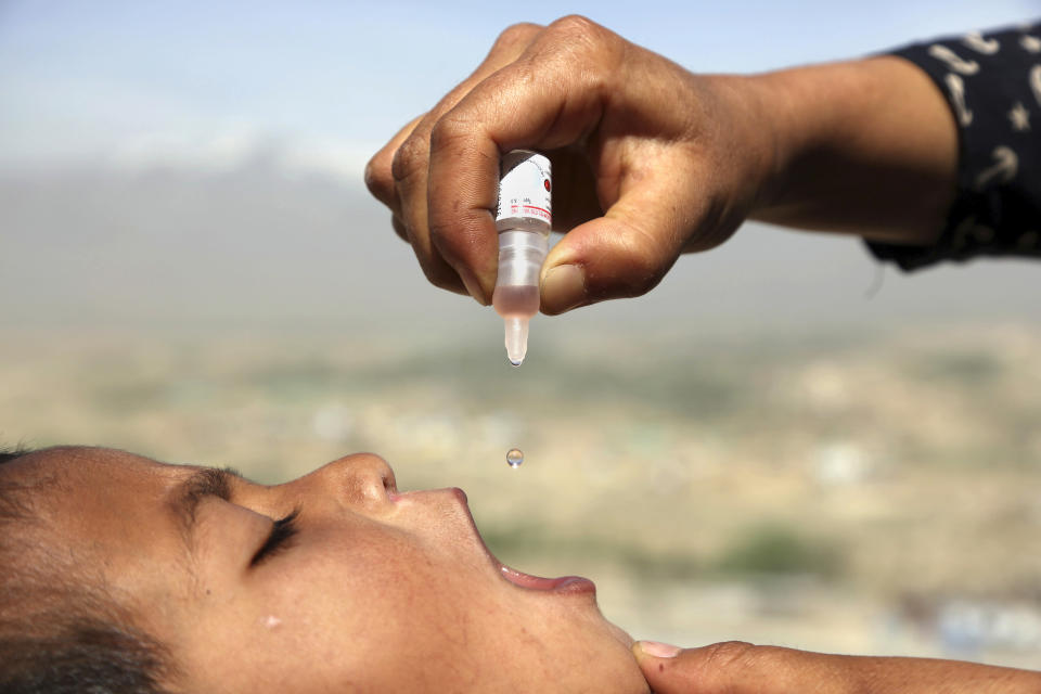 FILE - An Afghan health worker uses an oral polio vaccine on a child as part of a campaign to eliminate polio, on the outskirts of Kabul, Afghanistan, April 18, 2017. For years, global health officials have used billions of drops of an oral vaccine in a remarkably effective campaign aimed at wiping out polio in its last remaining strongholds — typically, poor, politically unstable corners of the world. Now, in a surprising twist in the decades-long effort to eradicate the virus, authorities in Jerusalem, New York and London have discovered evidence that polio is spreading there. The source of the virus? The oral vaccine itself. (AP Photo/Rahmat Gul, File)