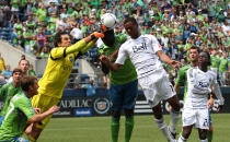 SEATTLE, WA - AUGUST 18: Goalkeeper Michael Gspurning #1 of the Seattle Sounders FC blocks a shot by Carlyle Mitchell #19 of the Vancouver Whitecaps at CenturyLink Field on August 18, 2012 in Seattle, Washington. The Sounders defeated the Whitecaps 2-0. (Photo by Otto Greule Jr/Getty Images)