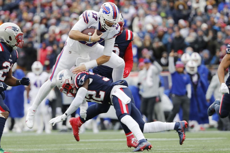 Buffalo quarterback Josh Allen jumps over New England's Devin McCourty during their game in Decemer.