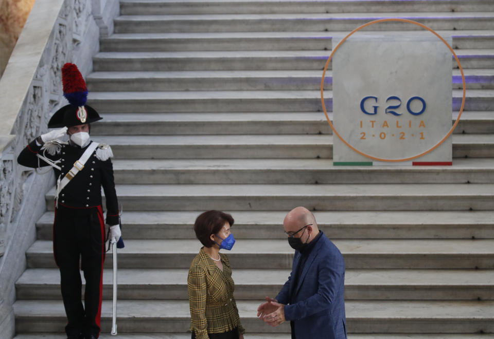 South Korea minister of environment, Han Jeoung-ae is welcomed by Italian Minister for Ecological Transition Roberto Cingolani as she arrives at Palazzo Reale in Naples, Italy, Thursday, July 22, 2021, to take part in a G20 meeting on environment, climate and energy. (AP Photo/Salvatore Laporta)