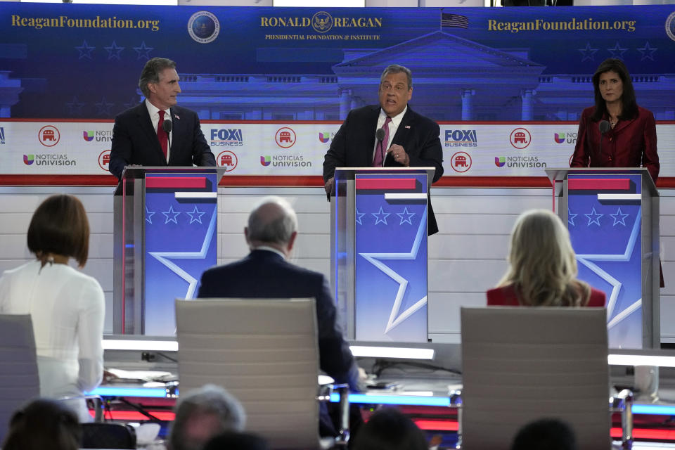 Former New Jersey Gov. Chris Christie, center, argues a point between North Dakota Gov. Doug Burgum, left, and former U.N. Ambassador Nikki Haley, during a Republican presidential primary debate hosted by FOX Business Network and Univision, Wednesday, Sept. 27, 2023, at the Ronald Reagan Presidential Library in Simi Valley, Calif. (AP Photo/Mark J. Terrill)