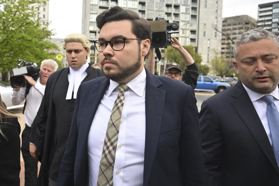 Bruce Lehrmann, center, arrives at the Australian Capital Territory Supreme Court in Canberra, Australia, Tuesday, Oct. 4, 2022. A judge reminded potential jurors in a high-profile Australian rape trial on Tuesday of the importance of impartiality. Former government staffer, Lehrmann, is charged with raping fellow staffer Brittany Higgins in the then-Defense Industry Minister Linda Reynolds' office in Parliament House in March 2019.(Mick Tsikas/AAP Image via AP)