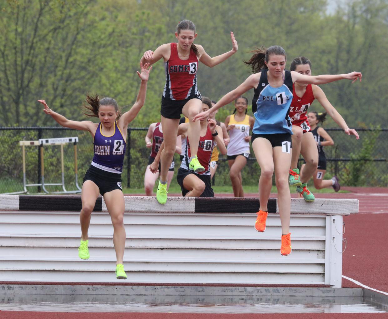 Sloane Wasserman from John Jay (Cross River), left, placed first as athletes compete in the girls 2000 Meter Steeplechase during the Gold Rush Invitational Track & Field meet at Clarkstown South High School in West Nyack, April 29, 2023. 