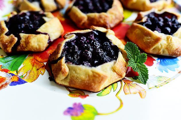 <p>This elegant dessert is a gorgeous ending to any party. Your guests won't even know how easy it was to make using store-bought pie crust. </p><p><a href="https://www.thepioneerwoman.com/food-cooking/recipes/a11779/mini-blueberry-galettes/" rel="nofollow noopener" target="_blank" data-ylk="slk:Get Ree's recipe." class="link "><strong>Get Ree's recipe.</strong></a></p>