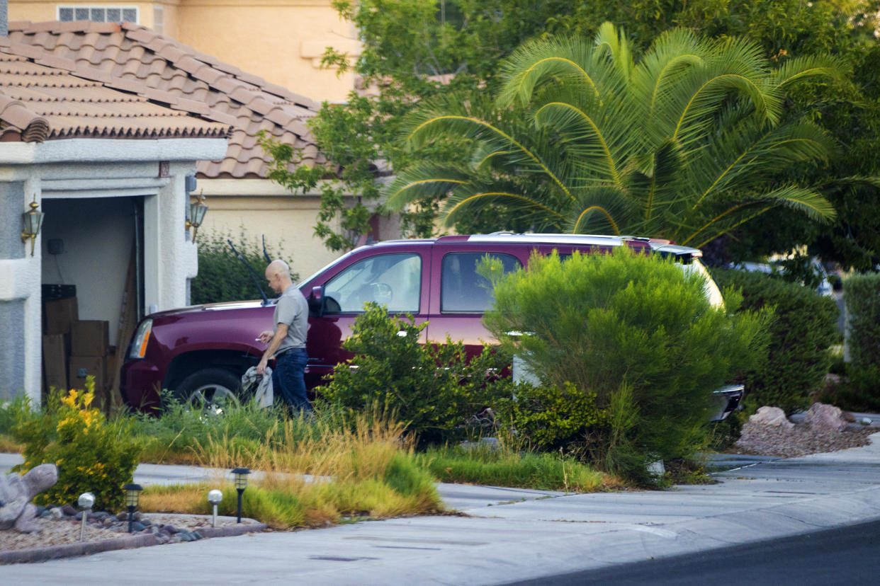 Outgoing Clark County Public Administrator Robert Telles washes his car outside his home on Tuesday, Sept. 6, 2022, in Las Vegas. Authorities served search warrants at Telles home on Wednesday, Sept. 7, 2022, in connection with the fatal stabbing of Las Vegas Review-Journal investigative reporter Jeff German. (Benjamin Hager/Las Vegas Review-Journal via AP)