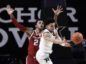 Vanderbilt guard Scotty Pippen Jr. (2) passes the ball away from Arkansas forward Vance Jackson (2) during the second half of an NCAA college basketball game against Vanderbilt Saturday, Jan. 23, 2021, in Nashville, Tenn. Arkansas won 92-71. (AP Photo/Mark Zaleski)