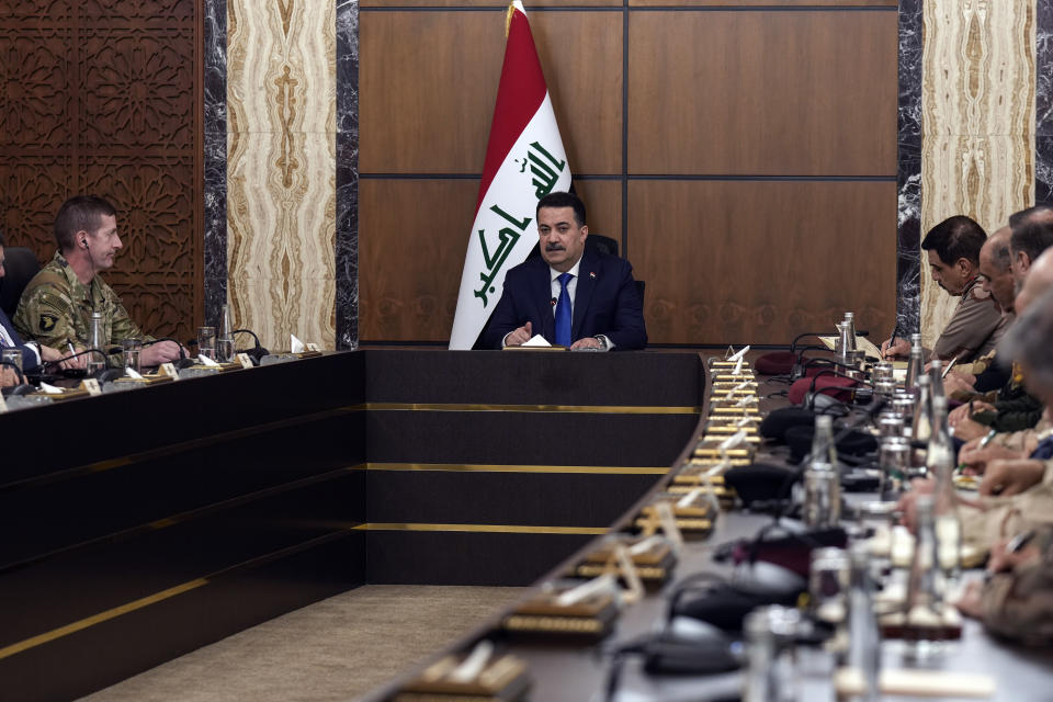 Iraqi Prime Minister Mohammed Shia al-Sudani, center, chairs the first sessions of negotiations between Iraq and the United States to wind down the U.S.-led international coalition mission in Baghdad, Iraq, Saturday, Jan. 27, 2024. (AP Photo/Hadi Mizban, Pool)