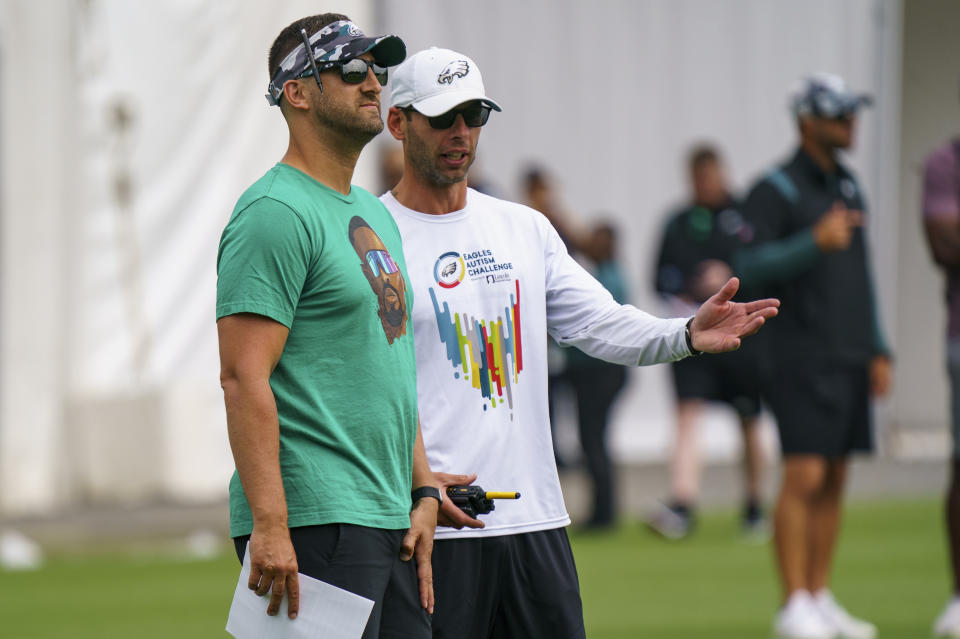 Philadelphia Eagles head coach Nick Sirianni, left, listens to defensive coordinator Jonathan Gannon, right, during the NFL football team's training camp, Wednesday, July 27, 2022, in Philadelphia. (AP Photo/Chris Szagola)