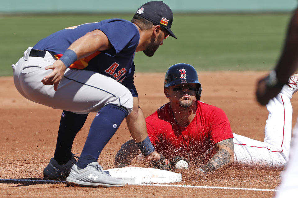 Houston Astros third baseman Abraham Toro tags Boston Red Sox's Michael Chavis who is out trying to steal third during a spring training baseball game, Thursday, March 5, 2020, in Fort Myers, Fla. (AP Photo/Elise Amendola)