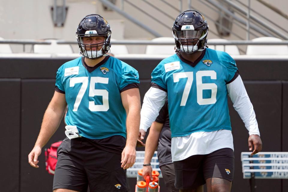 Jacksonville Jaguars guard Cooper Hodges (75) and offensive tackle Anton Harrison (76) take part in the NFL football team's rookie camp, Friday, May 12, 2023, in Jacksonville, Fla. (AP Photo/John Raoux)