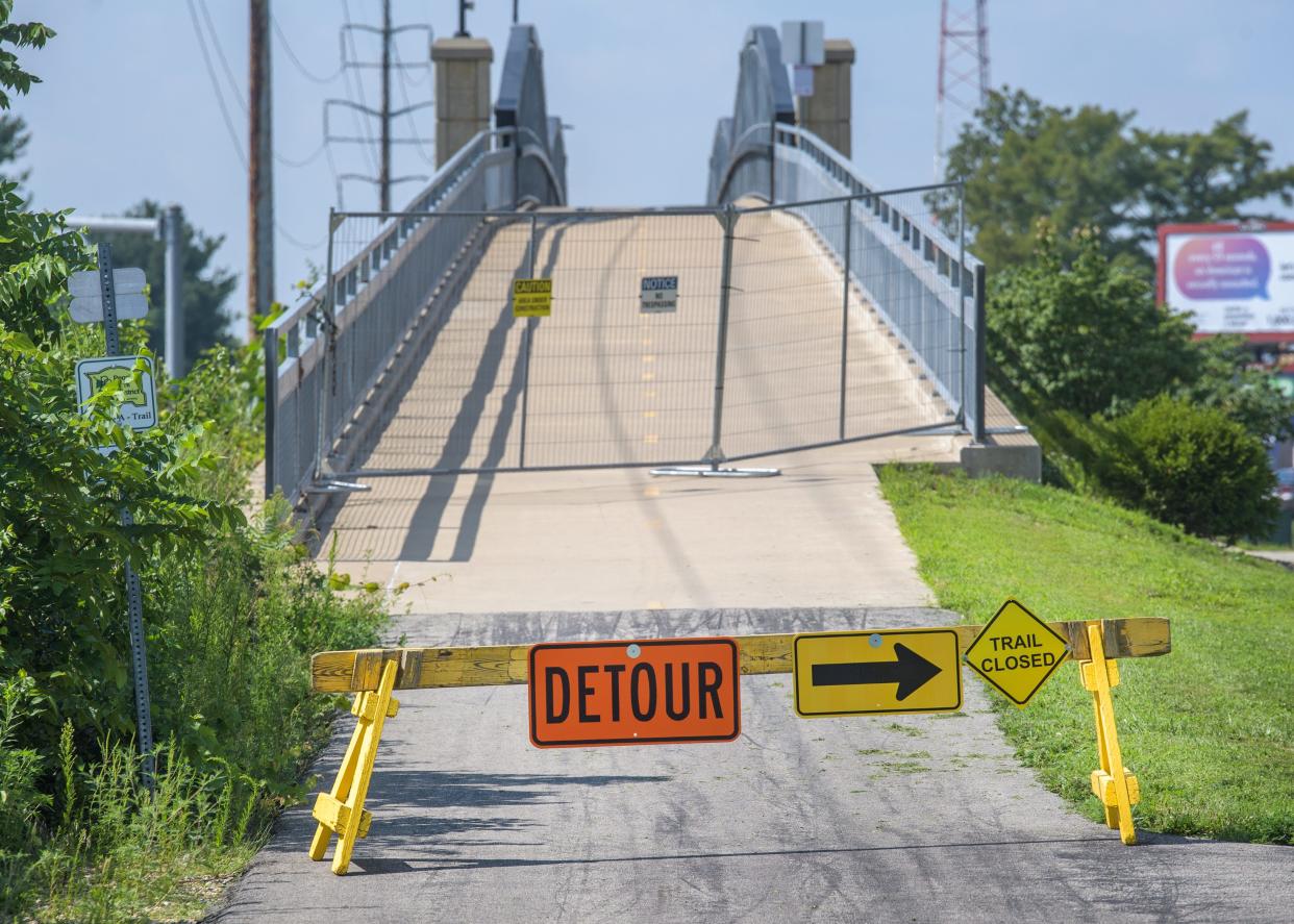 Fencing and a detour sign block the east side entrance of the Rock Island Greenway Bridger over Knoxville Avenue near Prospect Road in Peoria. The bridge will be closed through Aug. 21 for maintenance.