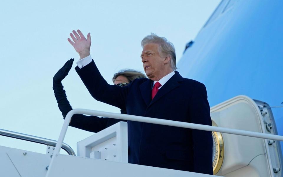 US President Donald Trump and First Lady Melania Trump wave as they board Air Force One - Alex Edelman/AFP