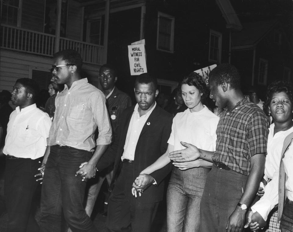 Civil Rights leaders, including future Congressman John Lewis (third left) and Gloria Richardson (third right), chair of the Cambridge Non-Violent Action Committee, links hands with others as they march in protest of a scheduled speech by pro-segregationist Alabama Gov. George Wallace in Cambridge, Md., May 1964. (Photo: Francis Miller/The LIFE Picture Collection via Getty Images)