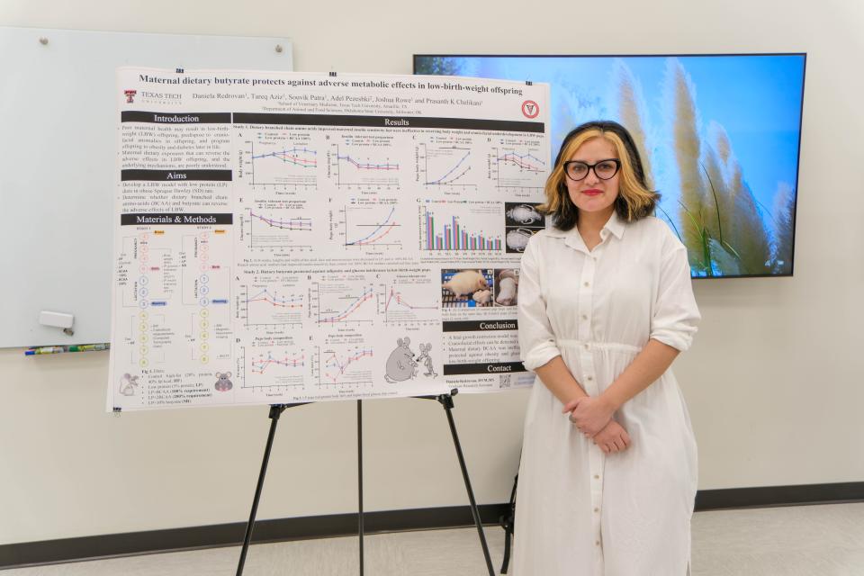 Daniela Redrovan, a graduate research assistant, stands in front of her poster research presentation at the inaugural Amarillo Research Symposium Friday at the Texas Tech School of Veterinary Medicine in Amarillo.