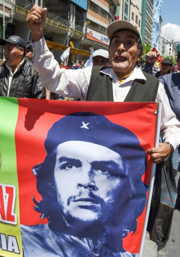 A supporter of Bolivian ex-President Evo Morales holds banner with an image of revolutionary leader Ernesto 'Che' Guevara during a demonstration Monday in La Paz