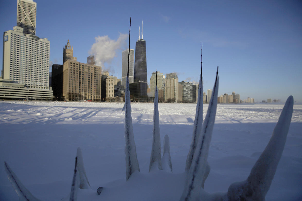 Ice forms along the shore of Lake Michigan before sunrise on Wednesday.&nbsp; (Photo: ASSOCIATED PRESS)