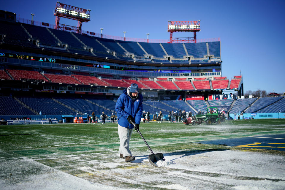 Dec 24, 2022; Nashville, Tennessee, USA;  Ground crews clear snow from the field before the Tennessee Titans take on the Houston Texans at Nissan Stadium. Mandatory Credit: Andrew Nelles-USA TODAY Sports