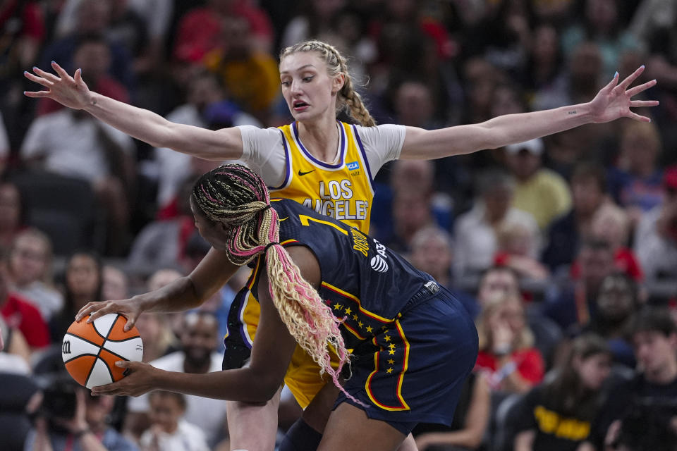 Los Angeles Sparks forward Cameron Brink (22) defends against Indiana Fever forward Aliyah Boston (7) during the second half of a WNBA basketball game in Indianapolis, Tuesday, May 28, 2024. (AP Photo/Michael Conroy)