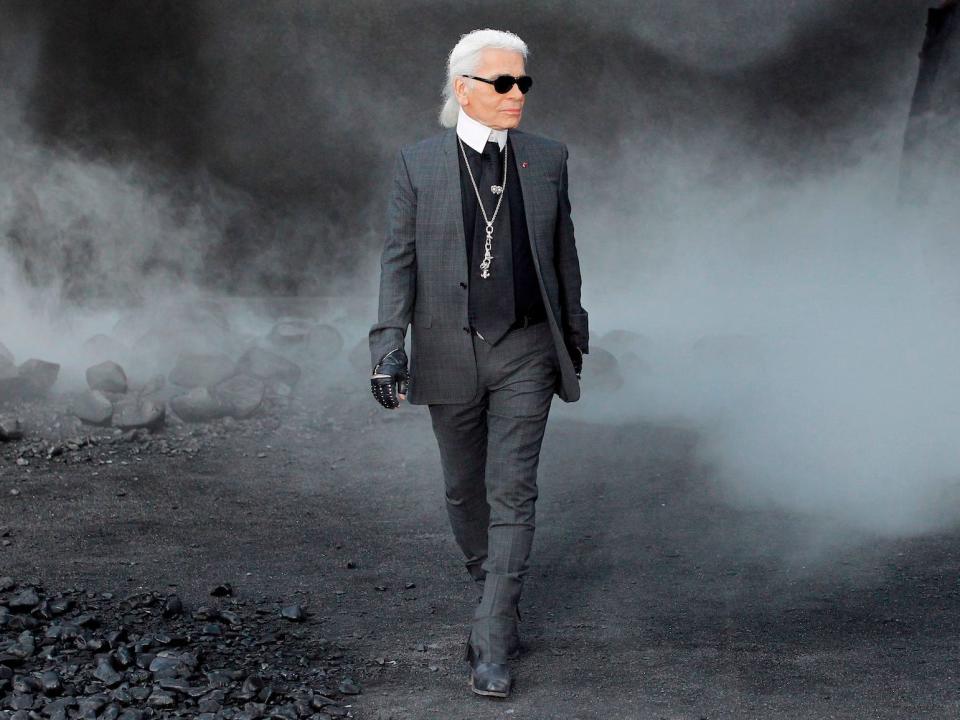 Karl Lagerfeld walks through a foggy area.