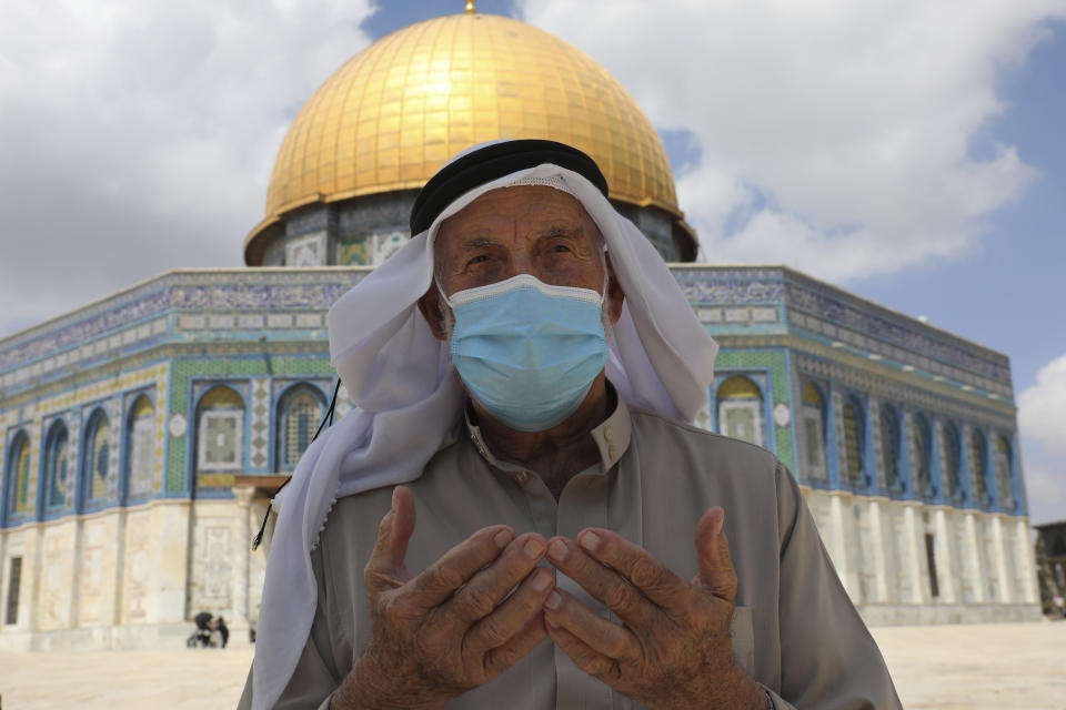 A Palestinian man prays at the Dome of the Rock Mosque in the Al Aqsa Mosque during Friday prayers before a protest celebrating the six Palestinian prisoners who recently tunneled out of the Gilboa Prison, in the Old City of Jerusalem, Friday, Sept. 10, 2021. (AP Photo/Mahmoud Illean)
