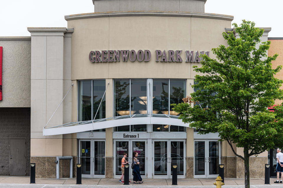 A group of people wait outside of an entrance to Greenwood Park Mall on July 18, 2022 in Greenwood, Indiana. A  / Credit: Getty Images