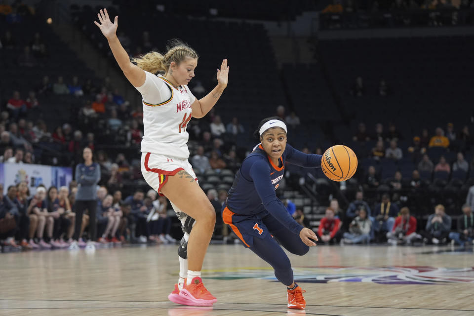 Illinois guard Makira Cook, right, works toward the basket as Maryland forward Allie Kubek defends during the first half of an NCAA college basketball game at the Big Ten women's tournament Thursday, March 7, 2024, in Minneapolis. (AP Photo/Abbie Parr)
