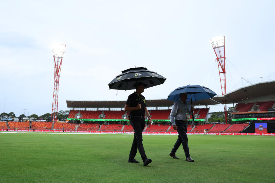 The match officials, pictured here amid a rain delay in the Melbourne Renegades and Sydney Thunder match.