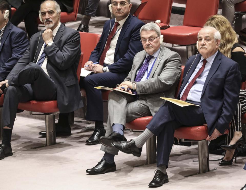 Syria United Nations Ambassador Bashar Jaafari, far left, Iraq U.N. Ambassador Mohammad Hussein Ali Bahr Aluloom, second from right, and Palestine's Permanent Observer to the United Nations Ambassador Riyad Mansour, far right, listen from the observer's seats during a meeting of the United Nations Security Council on the Mideast, Tuesday, Aug. 20, 2019 at U.N. headquarters. (AP Photo/Bebeto Matthews)