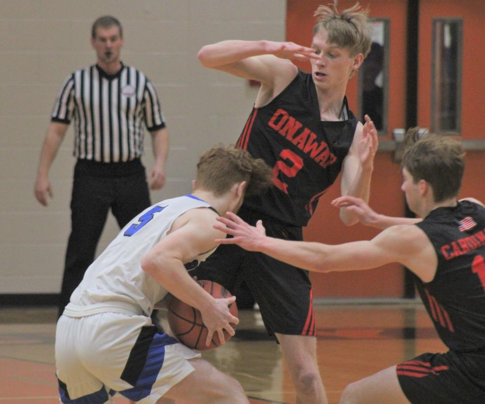 Onaway seniors Jadin Mix (2) and Jackson Chaskey (right) attempt to trap Inland Lakes senior Noah Shugar (5) during a district final at Rogers City on Friday, March 1. The Cardinals will take on St. Ignace in a 7 p.m. MHSAA Division 4 regional semifinal clash at Inland Lakes on Tuesday.