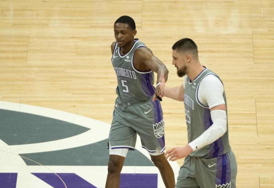 Sacramento Kings guard De’Aaron Fox (5) and Sacramento Kings center Alex Len (25) walk to bench after basket during Game 5 of the first-round NBA playoff series at Golden 1 Center on Wednesday.