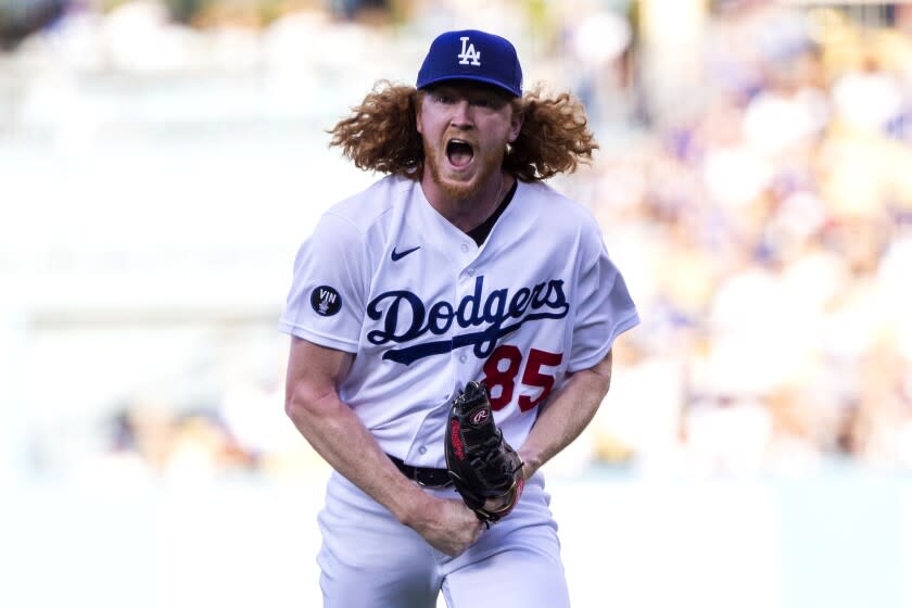 Los Angeles Dodgers starting pitcher Dustin May reacts on the mound after striking out.