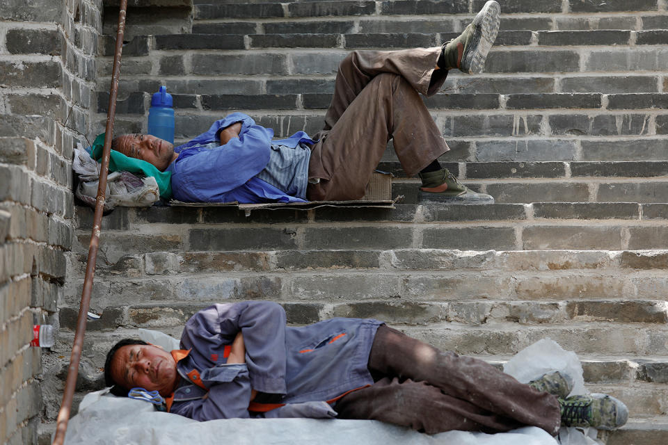 <p>People rest after working on the reconstruction of the Jiankou section of the Great Wall, located in Huairou District, north of Beijing, China, June 7, 2017. (Photo: Damir Sagolj/Reuters) </p>