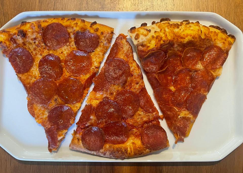 Three slices of pizza on a white plate