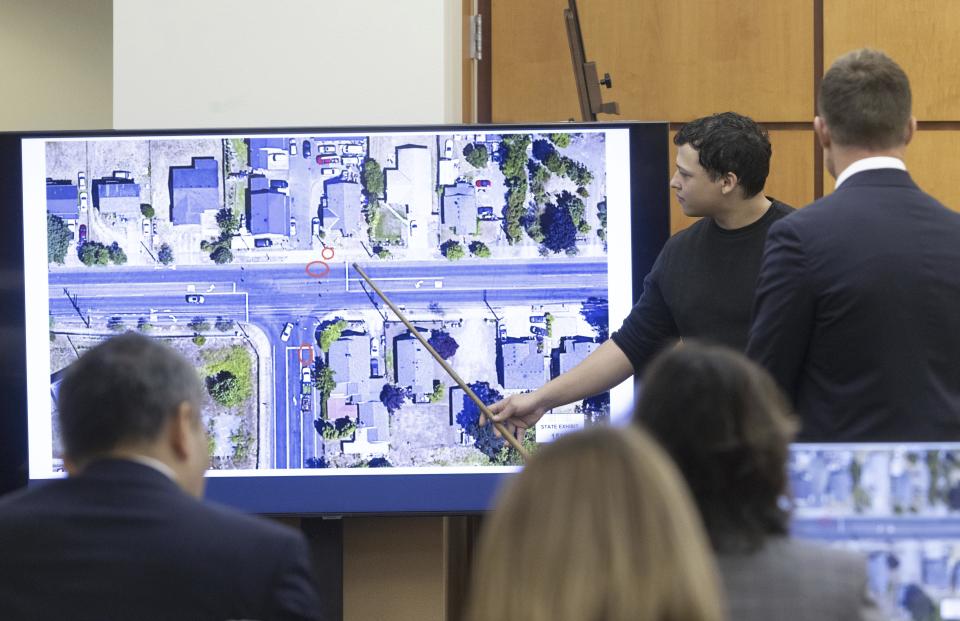 Witness Seth Cowden, who filmed a video of the beating and killing of Manny Ellis, points to where he says a Tacoma police officer's car was parked in an aerial view of the scene in Pierce County Superior Court Wednesday, Oct. 18, 2023, in Tacoma, Wash. Tacoma Police Officers Christopher Burbank, Matthew Collins and Timothy Rankine are on trial for the killing of Manny Ellis on March 3, 2020.. (Ellen M. Banner/The Seattle Times via AP, Pool)