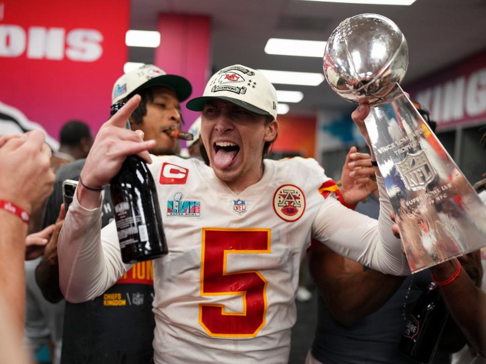 Chiefs punter Tommy Townsend poses with the Lombardi Trophy and a bottle of bubbly.