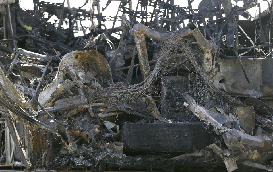 The burned interior of a tour bus that was struck by a FedEx truck on Interstate 5 Thursday is shown at a CalTrans maintenance station in Willows, Calif., Friday, April 11, 2014. At least ten people were killed and dozens injured in the fiery crash between the truck and a bus carrying high school students on a visit to a Northern California college. (AP Photo/Jeff Chiu)