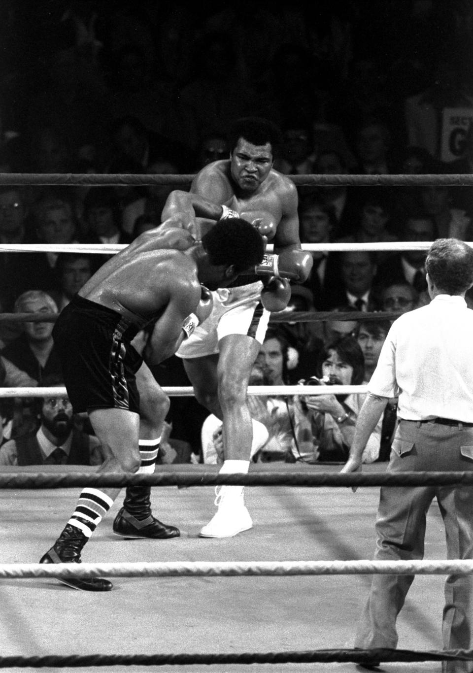 FILE - In this 1978 photo taken by Leonard Ignelzi, Muhammad Ali connects with a right cross to the head of challenger Leon Spinks during the third round of a boxing bout in Las Vegas. Ignelzi, whose knack for being in the right place at the right time produced breathtaking images of Hall of Fame sports figures, life along the U.S.-Mexico border, devastating wildfires and numerous other major news events over nearly four decades as a photographer for The Associated Press in San Diego, has died. He was 74. (AP Photo/Lenny Ignelzi, File)