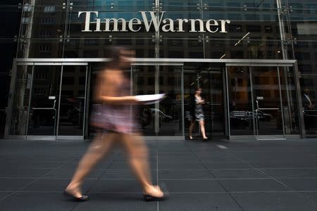 A woman walks past the Time Warner Center near Columbus Circle in Manhattan, New York July 16, 2014. REUTERS/Adrees Latif