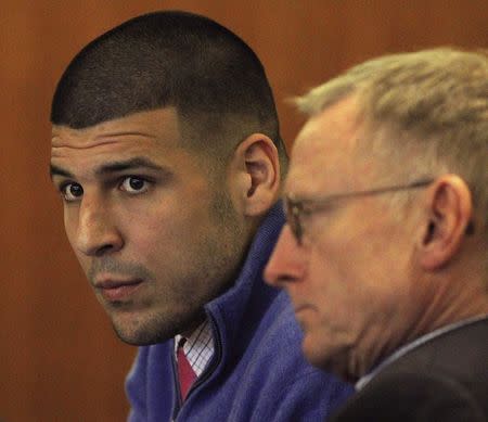 Aaron Hernandez, (L), and lawyer Charles Rankin attend an evidentiary hearing at Bristol County Superior Court in Fall River, Massachusetts October1, 2014. REUTERS/Wendy Maeda/Pool