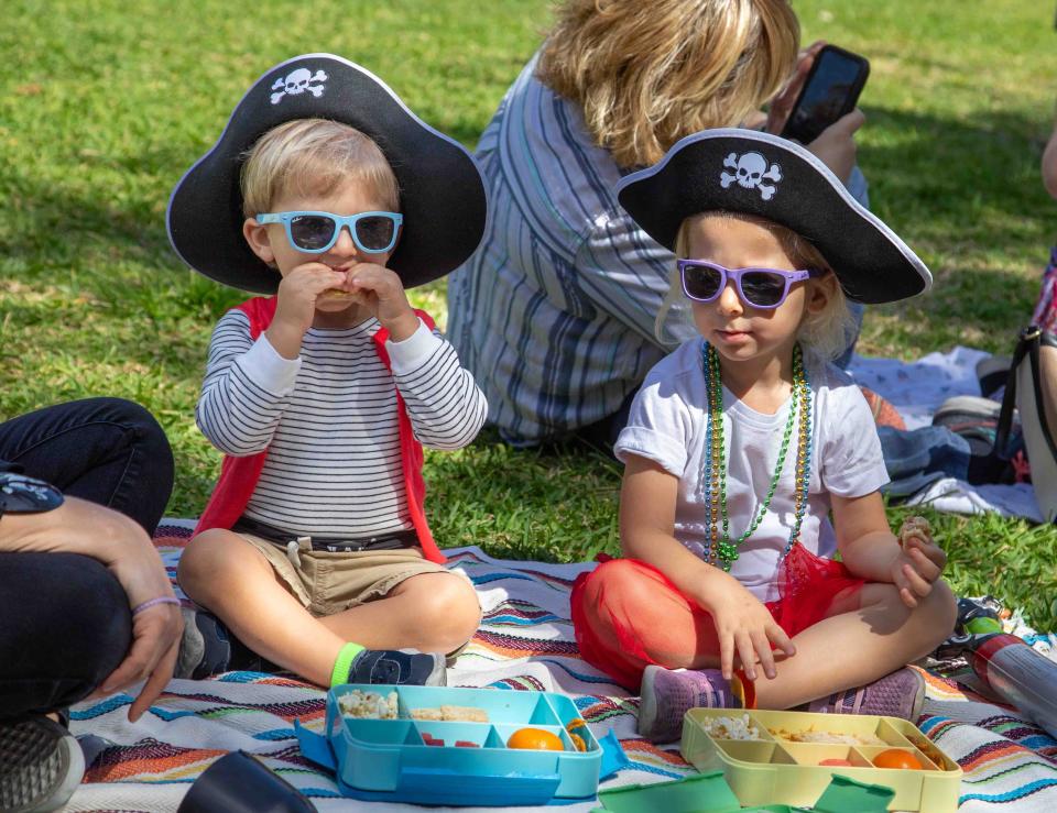 Blake King, 2, and his sister Lizzy, 3, enjoy a snack while dressed as pirates during the Preschool Story Time Pirate Day event at the Society of the Four Arts on April 29.