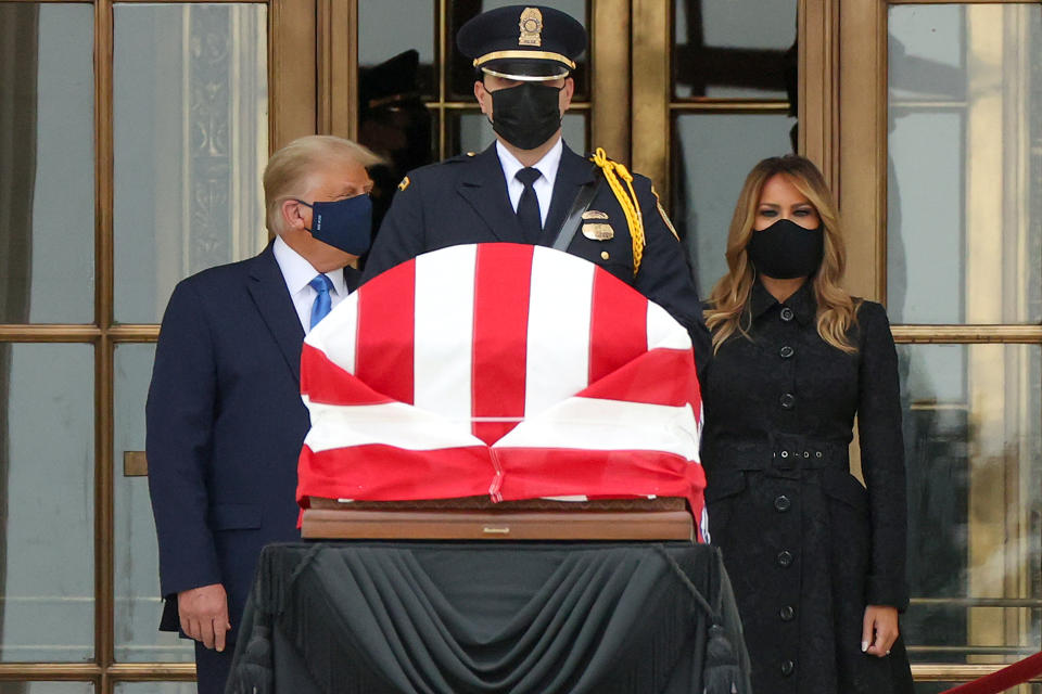 US President Donald Trump and First Lady Melania Trump stand next to Justice Ruth Bader Ginsburg's casket.